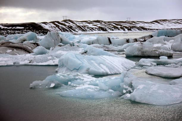 istock Blue icebergs floating on a dark sea 664434576