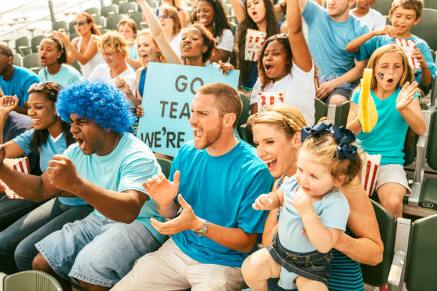 istock Crowd of fans cheering from stadium bleachers 664435336