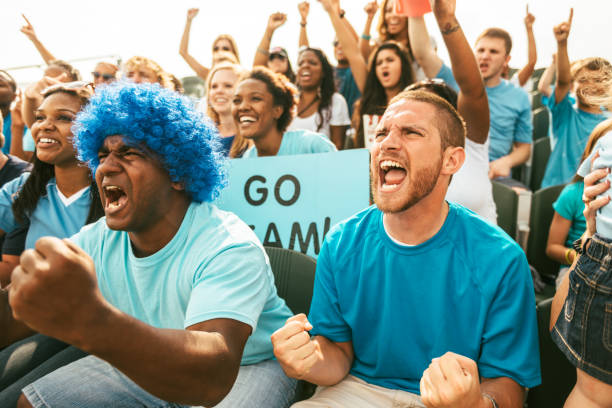 istock Crowd of fans cheering from stadium bleachers 664440018