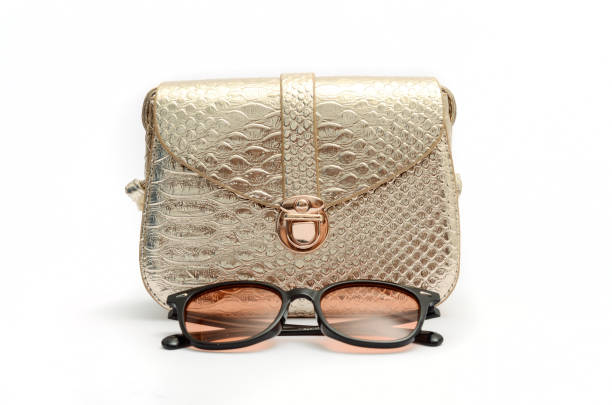 istock Golden clutch and sunglasses still life 664440090