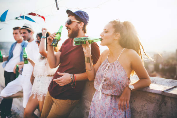 istock Best friends drinking on a rooftop party 664442902