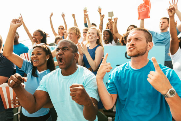 istock Crowd of fans cheering from stadium bleachers 664442962