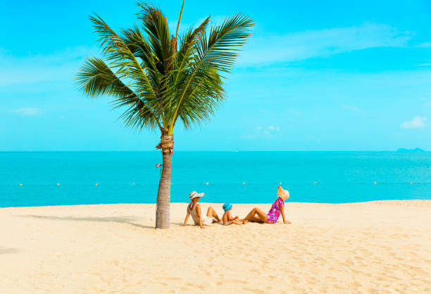 istock Woman with baby on the beach 664446482