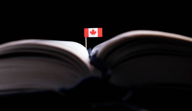 Canadian flag in the middle of the book. Knowledge and education concept. stock photo