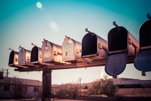 A line of mailboxes or postal boxes on a summer afternoon in New Jersey.