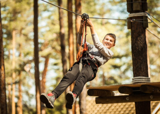Boy at Adrenaline Park Young boy at the ropes course, enjoying adrenaline park adventure 2667 stock pictures, royalty-free photos & images