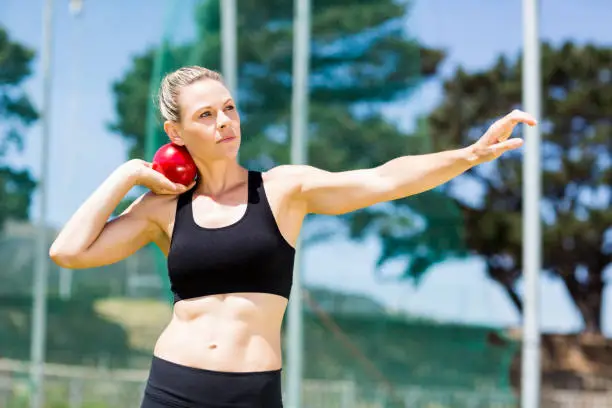 Photo of Female athlete preparing to throw shot put ball