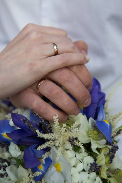 istock Bride and groom holding hands, wedding rings 664462974