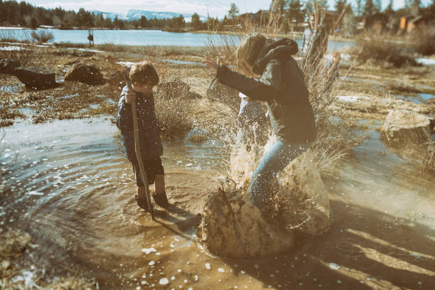 istock Mother creates a huge splash while playing with her children 664466786