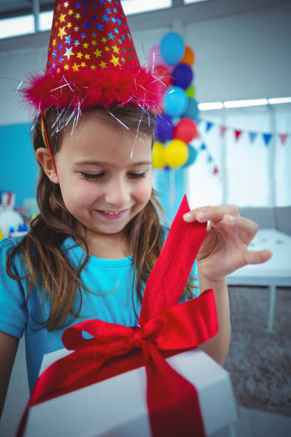 istock Smiling girl holding a present 664467384