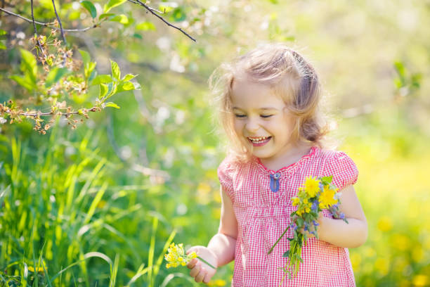istock Happy little girl in spring sunny park 664471142