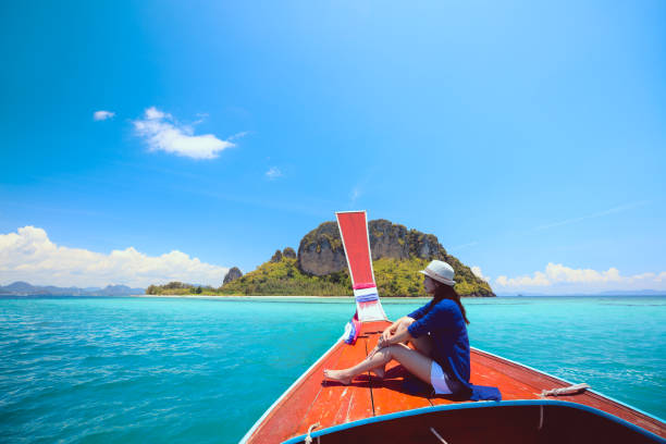 istock Happy female traveling on boat 664490456