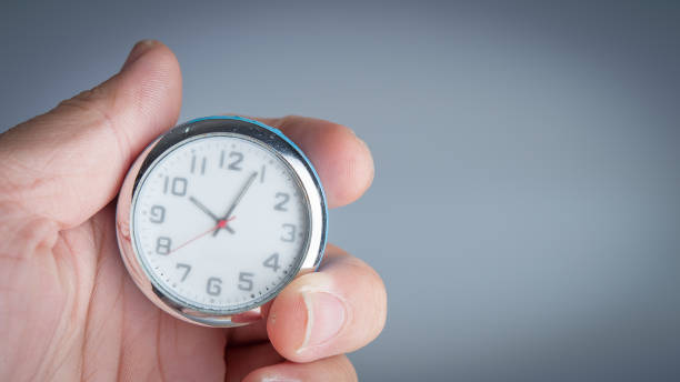 istock Male hand holding clock. Time management concept. Time control, planning. 664497314