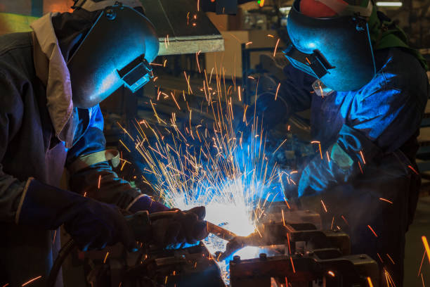 istock Workers are welding automotive part in factory 664498218