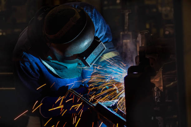 istock worker is welding automotive part in factory 664498244