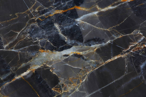 istock White and yellow patterned of dark gray marble texture background. 664501930
