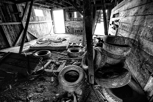 Old Abandonded Barn on Outskirts of City - Encroaching urban sprawl on old rural farm area. Broomfield/Westminster, Colorado USA. Tires and other litter.