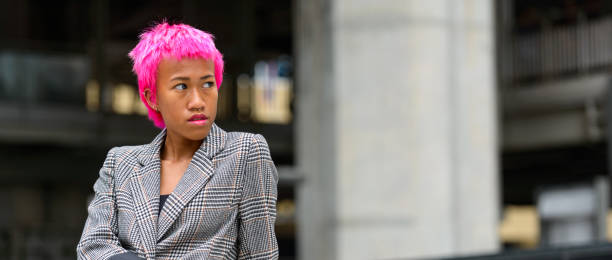 istock Beautiful rebellious young woman with short pink hairstyle sitting while looking back 664505176