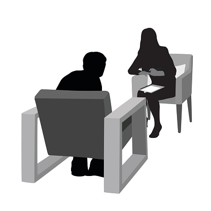 A vector silhouette illustration of a therapist discussing issues with a patient.  The female Doctor sits and writes on a clipboard while the patient is hunched over on a chair.