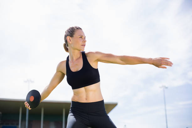 Female athlete about to throw a discus