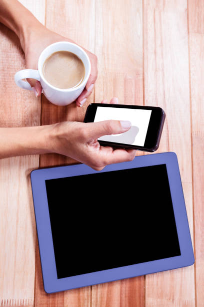 istock Businesswoman holding smartphone and coffee cup 664514488