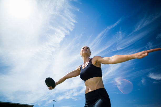 istock Female athlete about to throw a discus 664514494