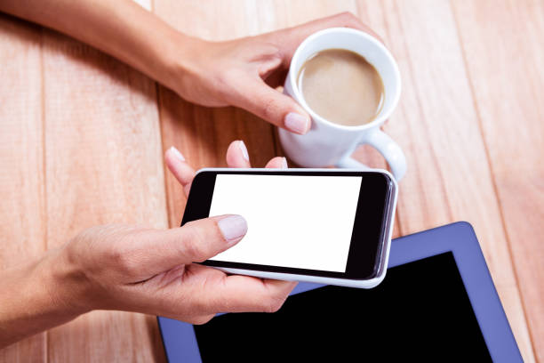 istock Businesswoman holding smartphone and coffee cup 664514828