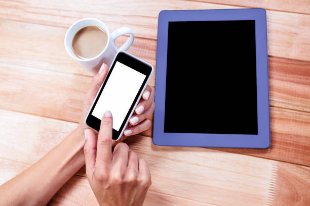 istock Businesswoman using her smartphone on desk 664514862