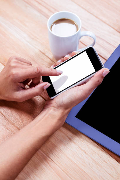 istock Businesswoman using her smartphone on desk 664514962