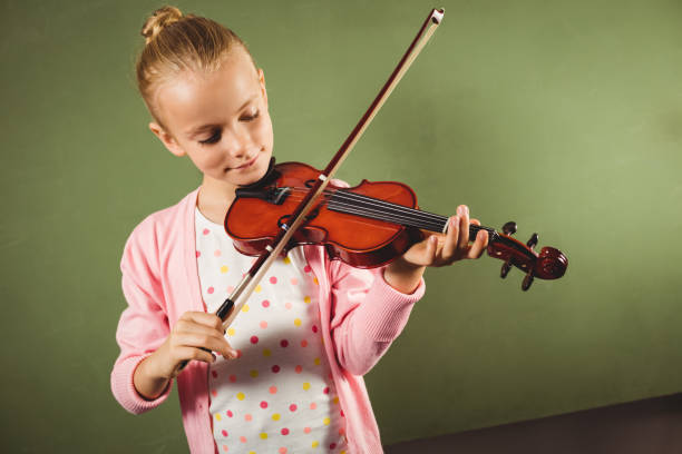 istock Girl playing the violin 664517652