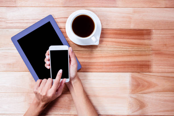 istock Businesswoman using her smartphone on desk 664518244