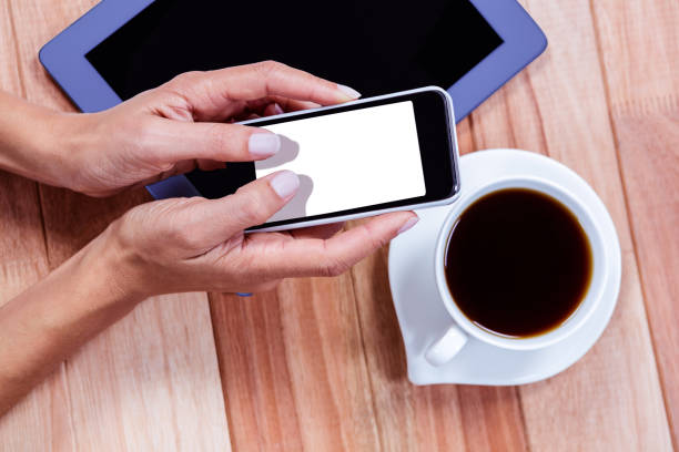 istock Businesswoman using her smartphone on desk 664518330