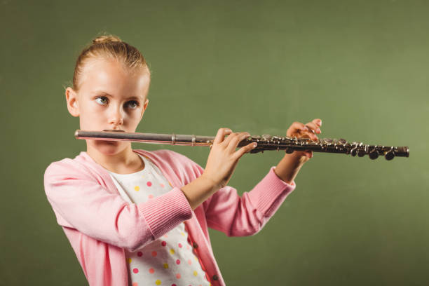 istock Girl playing the flute 664520772