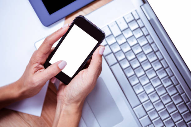 istock Businesswoman using her smartphone on desk 664520830