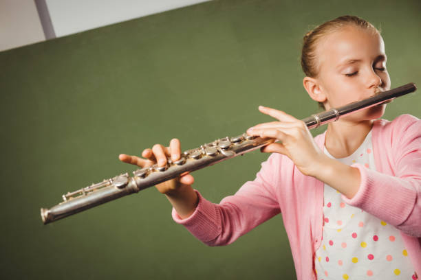 istock Girl playing the flute 664521224