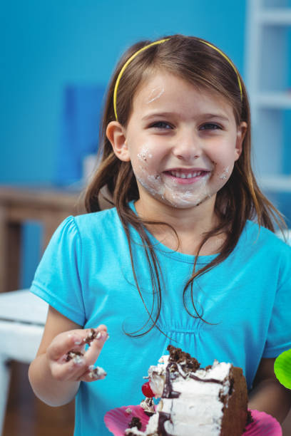 istock Happy kid eating birthday cake 664521258