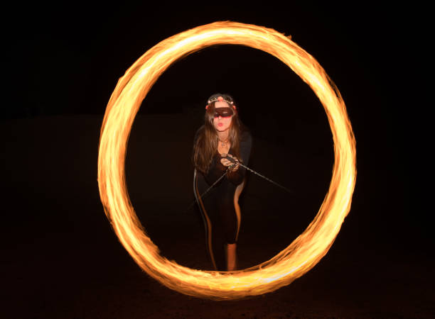 istock Dancer with flaming fire pois after dark. 664521952