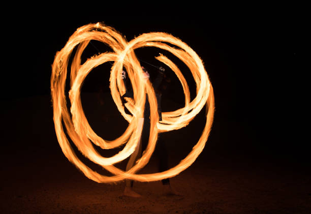 istock Dancer with flaming fire pois after dark. 664521972