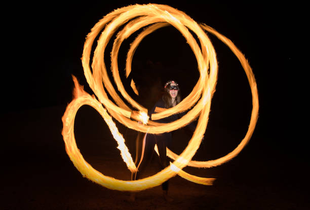 istock Dancer with flaming fire pois after dark. 664521974