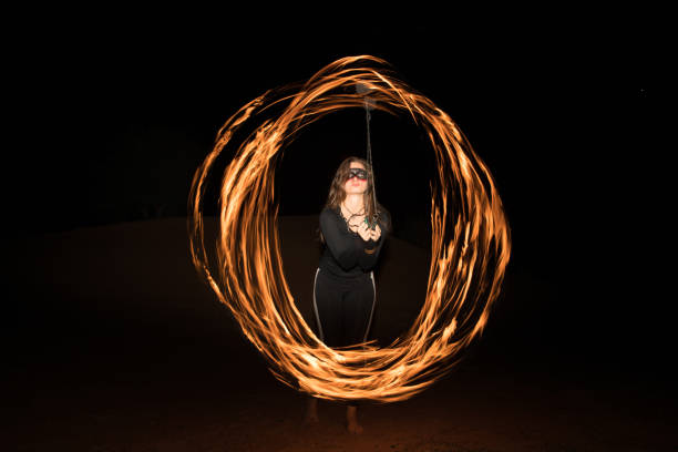 istock Dancer with flaming fire pois after dark. 664521976