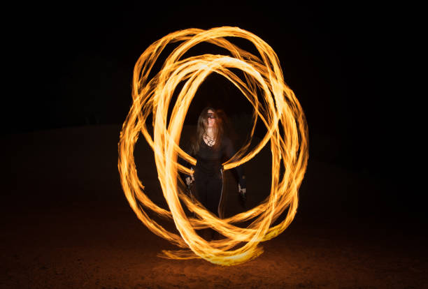 istock Dancer with flaming fire pois after dark. 664521978