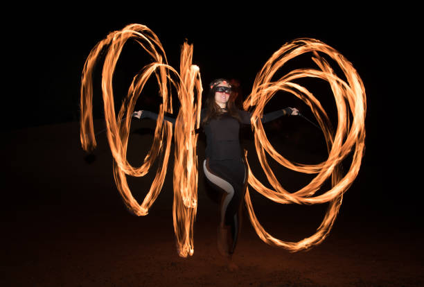 istock Dancer with flaming fire pois after dark. 664521982