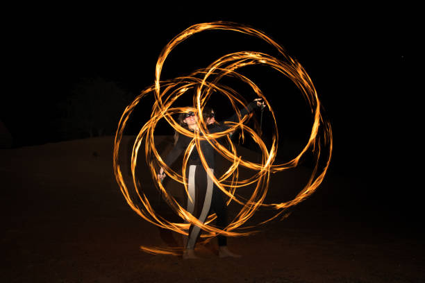 istock Dancer with flaming fire pois after dark. 664521984