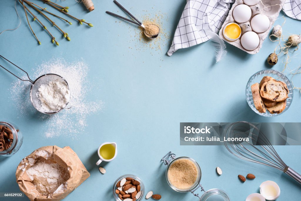 Baking or cooking frame. Ingredients, kitchen items for baking cakes. Baking or cooking background frame. Ingredients, kitchen items for baking cakes. Kitchen utensils, flour, eggs, almond, cinnamon, oil. Text space, top view. Baking Stock Photo