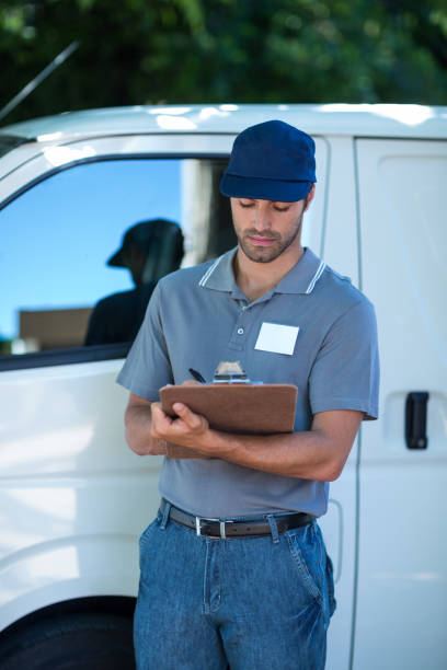 istock Delivery person writing in clipboard 664532272