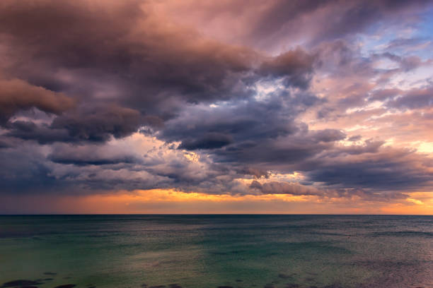 Exciting sunset Exciting sunset. Beautiful colorful clouds over the sea. moody sky stock pictures, royalty-free photos & images