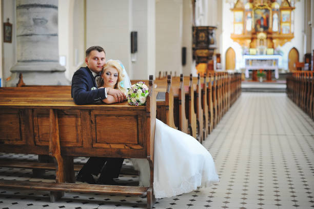 istock Wedding couple at catholic church 664532836