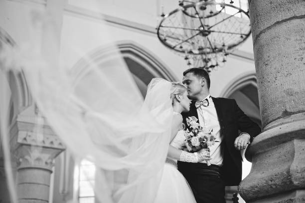 istock Wedding couple at catholic church 664532868
