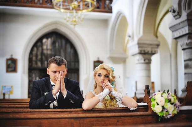 istock Wedding couple at catholic church 664532898