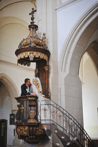 istock Wedding couple at catholic church 664532930